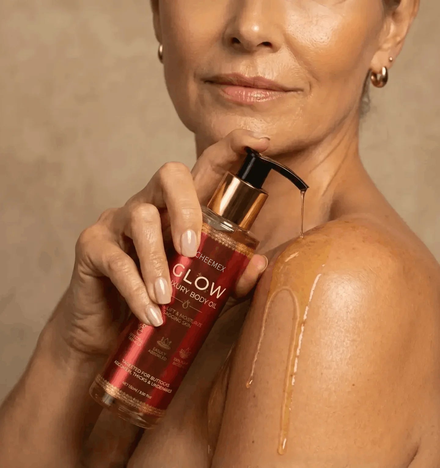 Woman applying Cheemex Glow Luxury Body Oil to her shoulder